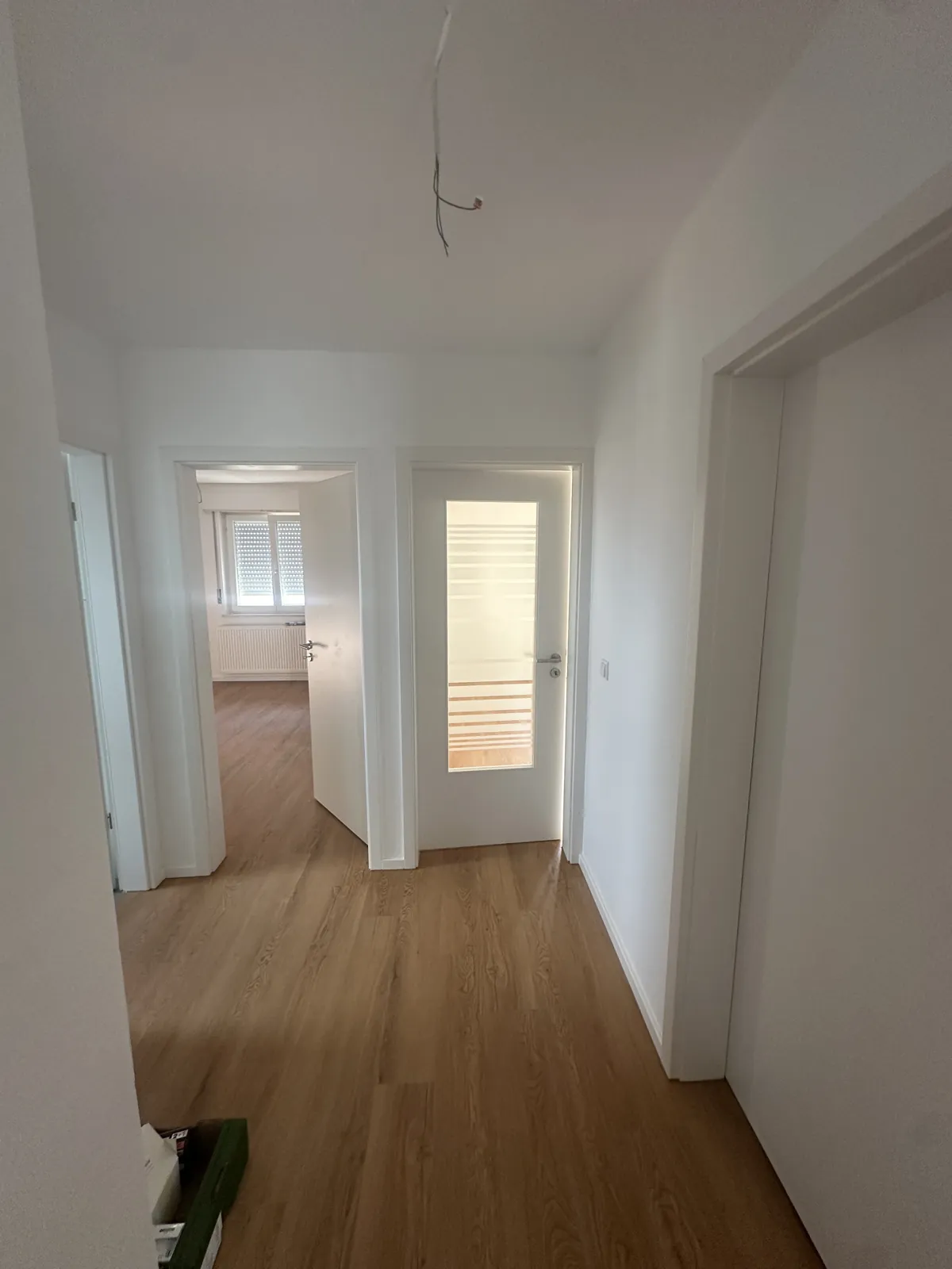 Sanierter Flur mit neuem Vinylboden und Blick in die angrenzenden Zimmer